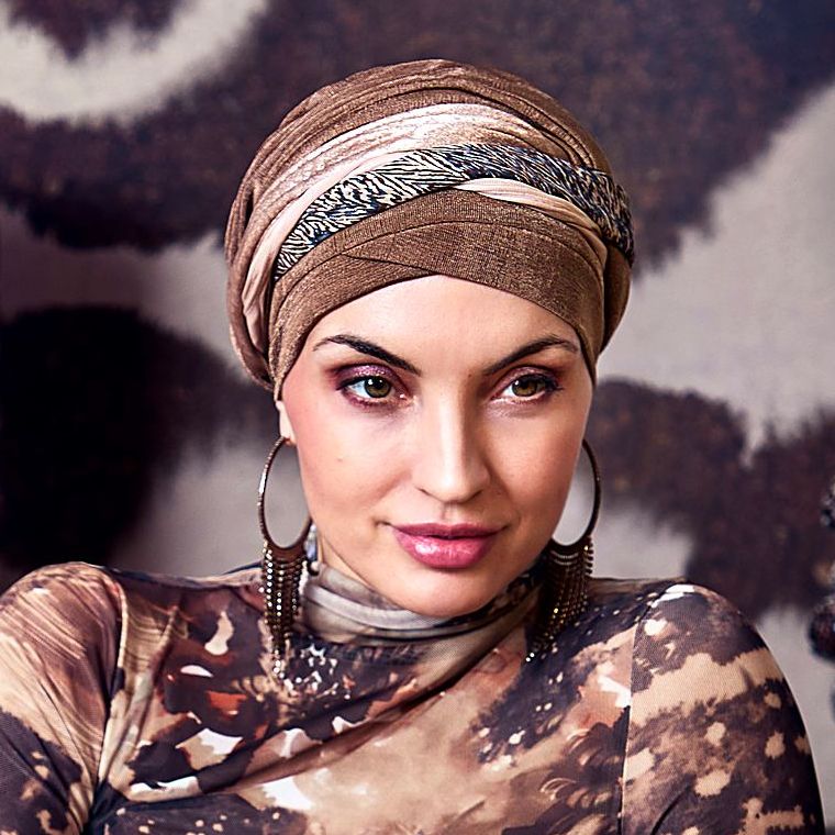 Frau mit gewickeltem Turban in Braun- und Goldtönen